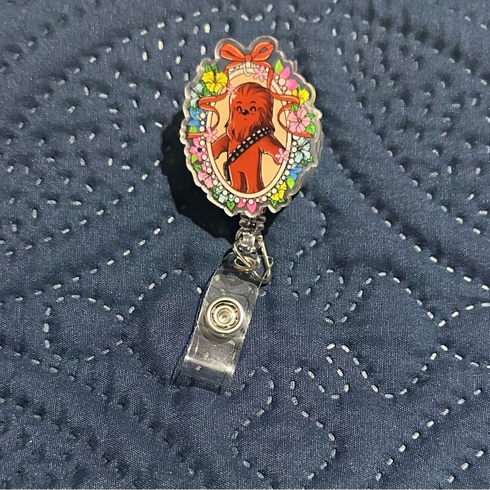 Charming Character Badge Reel with Floral Accents